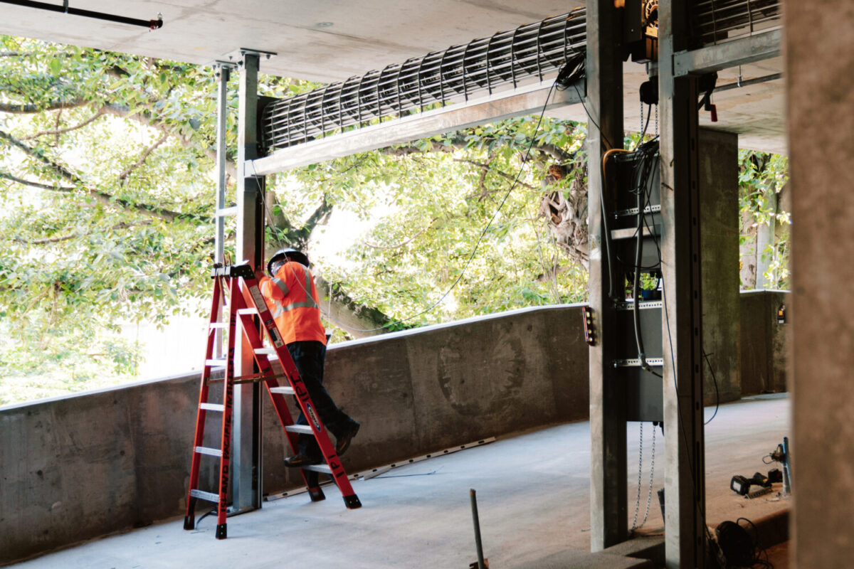 photo of IPD employee doing maintenance on a roll-up door